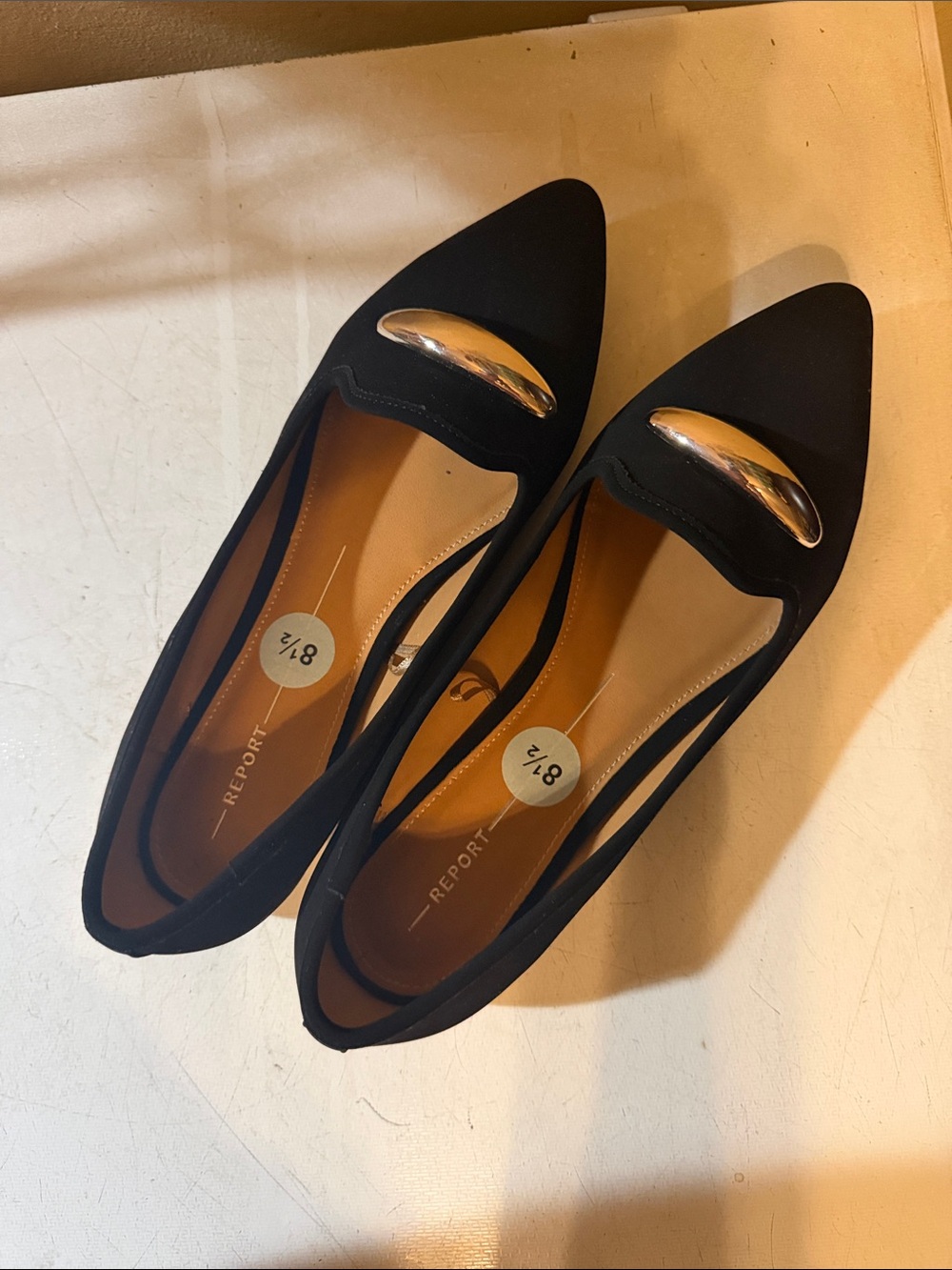 Report Black Pointed Flats with Gold Bar